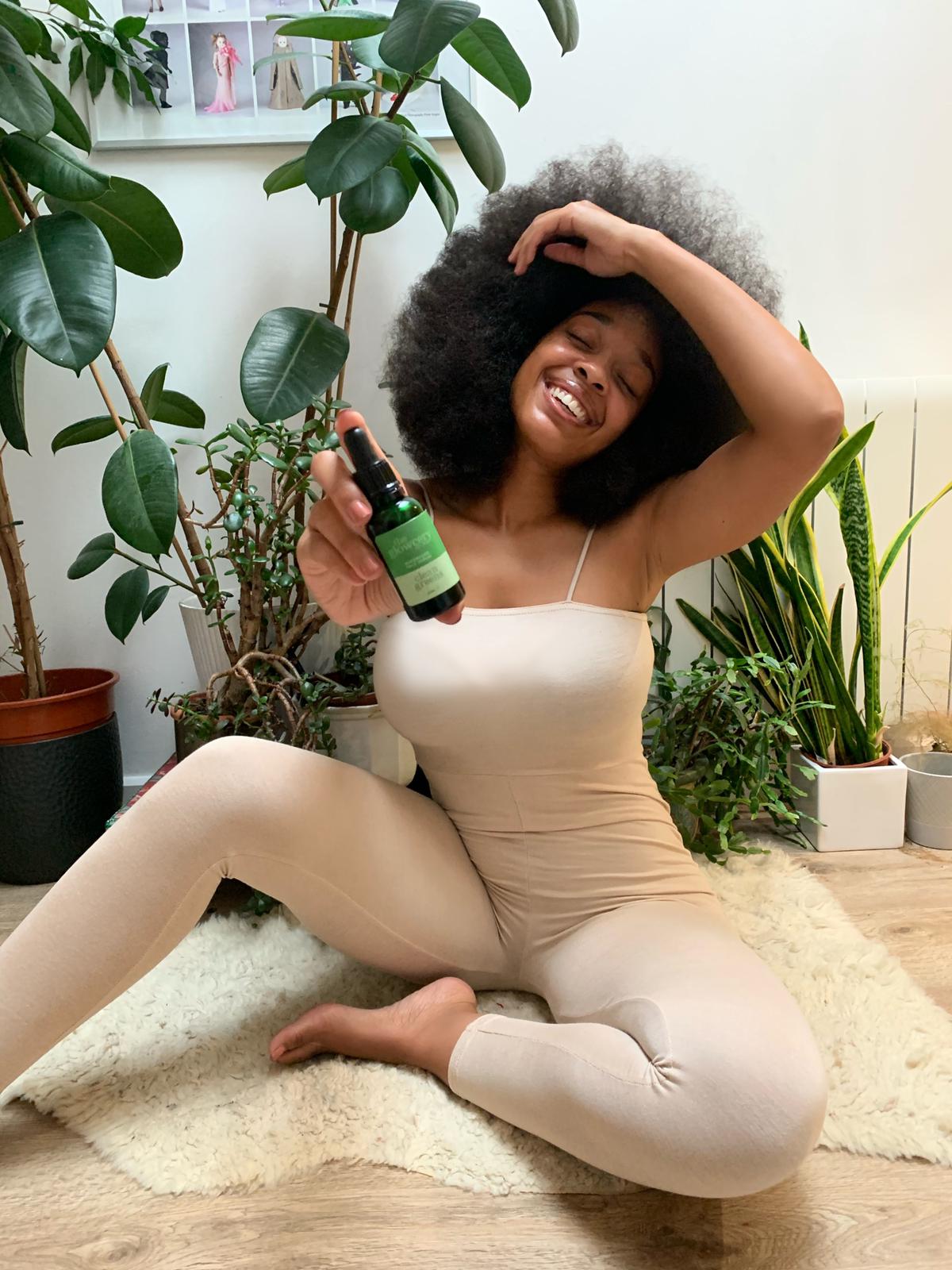 Imani Evans holding a bottle of Clean Greens